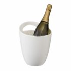 A champagne bottle chilling in a white ice bucket filled with ice. The bucket has a smooth surface and a handle at the top. The bottle is green with a gold foil covering the cork.