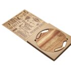A wooden cheese board set in an open cardboard box. The lid of the box is decorated with various cheese-related words and graphics, such as premium quality and aged cheddar. The board has curved handles on each side.