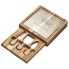 A wooden cheese board set with a sliding compartment displaying three cheese tools: a fork, a spreader, and a knife. The lid has a transparent top with a wine bottle and glasses design.