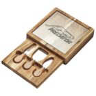 Wooden cheese board set with sliding top engraved with a jumping predator logo. Inside, there are three cheese tools: two knives and a fork, neatly arranged in carved slots. The wood has a natural, smooth finish.