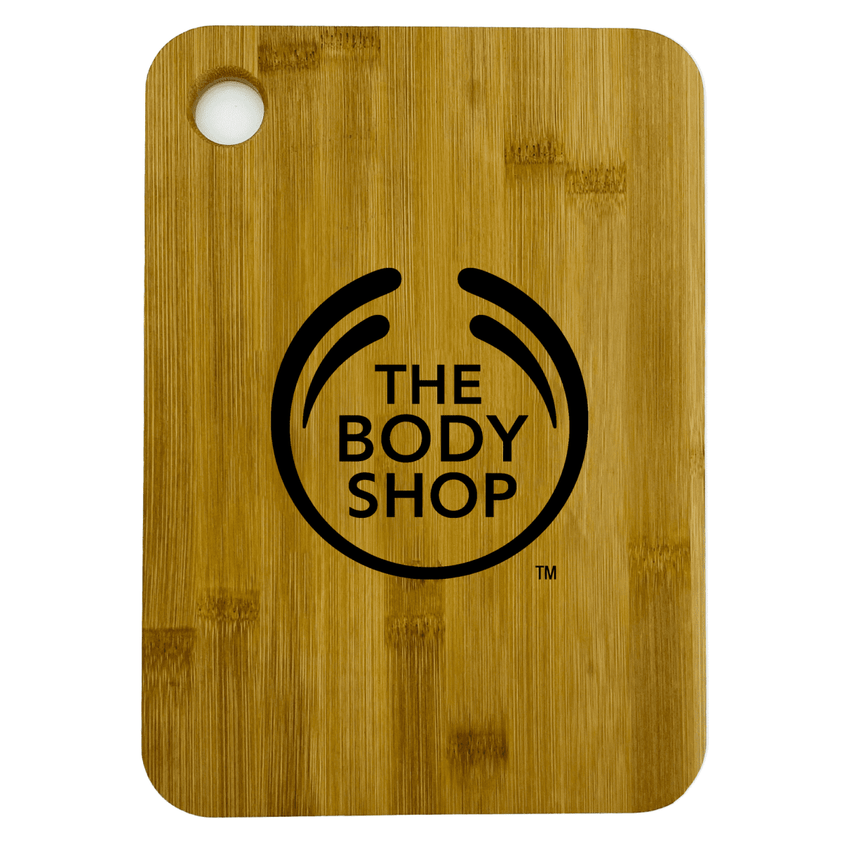 A wooden cutting board with a circular hole in the top left corner. It features The Body Shop logo in black in the center.
