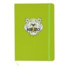 A lime green notebook with an illustrated tigers head logo on the front, featuring the text Kenzo Paris. It has rounded corners and an elastic band closure on the right side, matching the notebooks color.