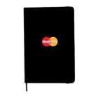 Black notebook with the Mastercard logo centered on the cover. The logo consists of two overlapping circles, one red and one orange, with Mastercard written in the center. A thin black ribbon bookmark hangs from the bottom.