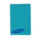 Teal notebook with the Samsung logo on the cover. It has rounded corners, a matching elastic band for closure, and a ribbon bookmark.