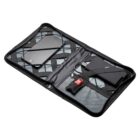 An open black zippered organizer with crisscross elastic bands holding a smartphone and other small items including a key ring, USB cable, and mesh pocket inside.