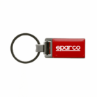 A rectangular red keychain with a metallic gray loop features the word sparco in white, bold lowercase letters. The simple design emphasizes the brand name.