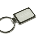 A rectangular metal keychain with a split ring. The keychain features a white insert with the word Fairway engraved on it. The design is simple and sleek, suitable for holding keys.