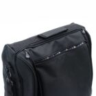 A black bag with a zippered pocket and a striped fabric lining peeking out. It has a handle on top and visible zipper pulls on the side.