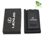 A black rectangular Lexus key fob is displayed next to its box. The box is black with the Lexus logo in white. A CO2 Neutral label is in the top right corner.