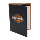 A black clipboard folder with the Harley-Davidson logo on the cover. The folder is partially open, revealing a lined notepad inside. The interior of the folder is tan.