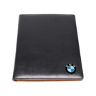 Black leather binder with the BMW logo in the bottom right corner.