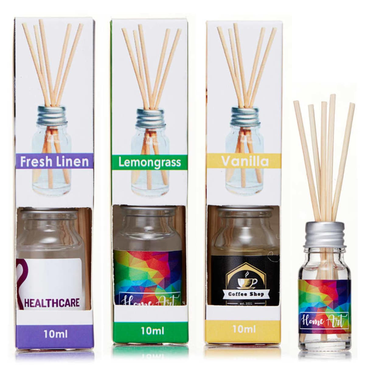 Three diffuser boxes labeled Fresh Linen, Lemongrass, and Vanilla, each with a 10ml bottle and reed sticks. Bottles show different designs: a healthcare logo, rainbow pattern, and coffee shop label.