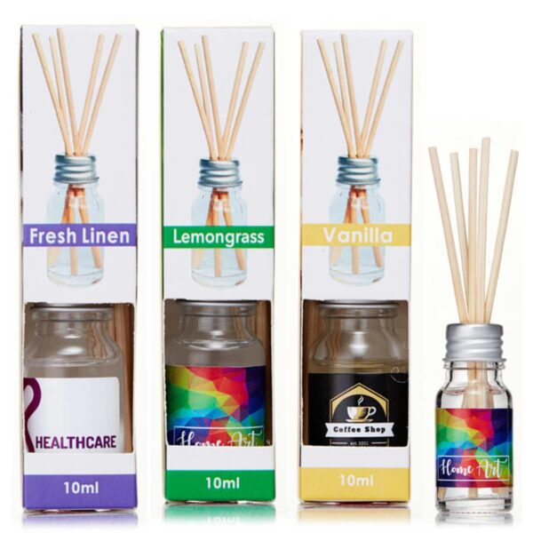 Three boxes of reed diffusers labeled Fresh Linen, Lemongrass, and Vanilla are displayed. Each box shows a glass bottle with sticks protruding from the top, and various colorful labels.