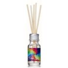 A glass bottle with a silver cap holds several wooden diffuser sticks. The bottle has a colorful geometrical label with the words Home Drt on it. The liquid inside is clear.