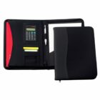A black zippered portfolio organizer is open, revealing a built-in calculator, pen holder, sticky notes, card slots, a notepad, and a red folder. The outer cover is partially visible, showcasing a sleek design.