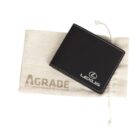 A black Lexus-branded wallet sits on a beige cloth pouch with the text AGRADE BECAUSE EVERYONE DESERVES AN UPGRADE partially visible. The wallet has white stitching and a sleek design.
