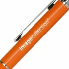 Close-up of an orange pen with a shiny silver clip. The pen has the text image collection printed in white.