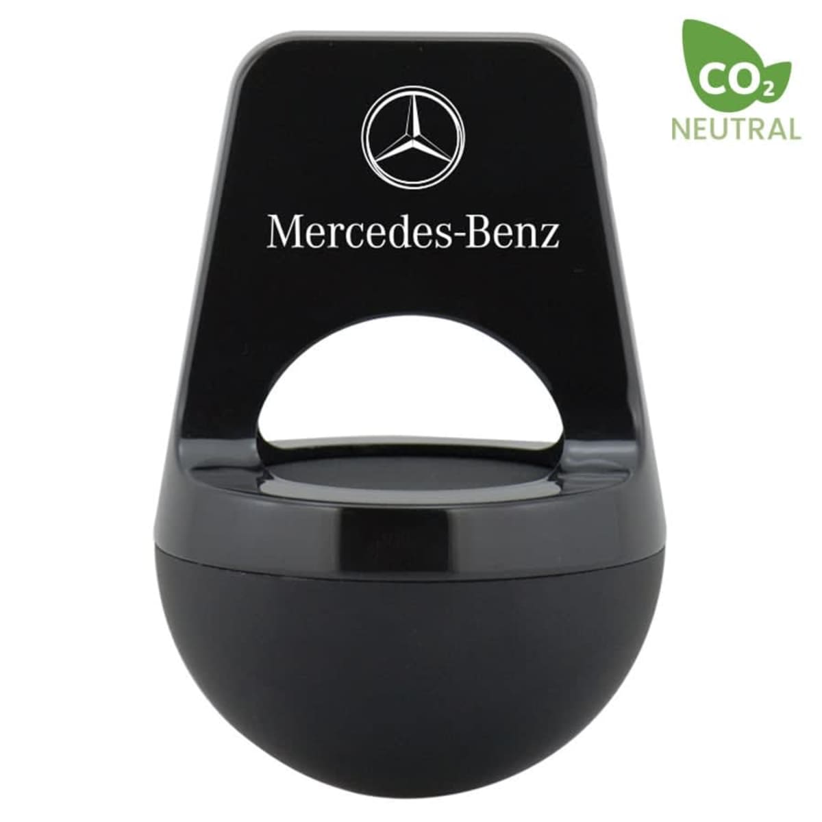 A black Mercedes-Benz air freshener with a round base and a rectangular top featuring the brand logo and name. It is labeled as CO2 neutral with a small green leaf symbol in the top right corner.