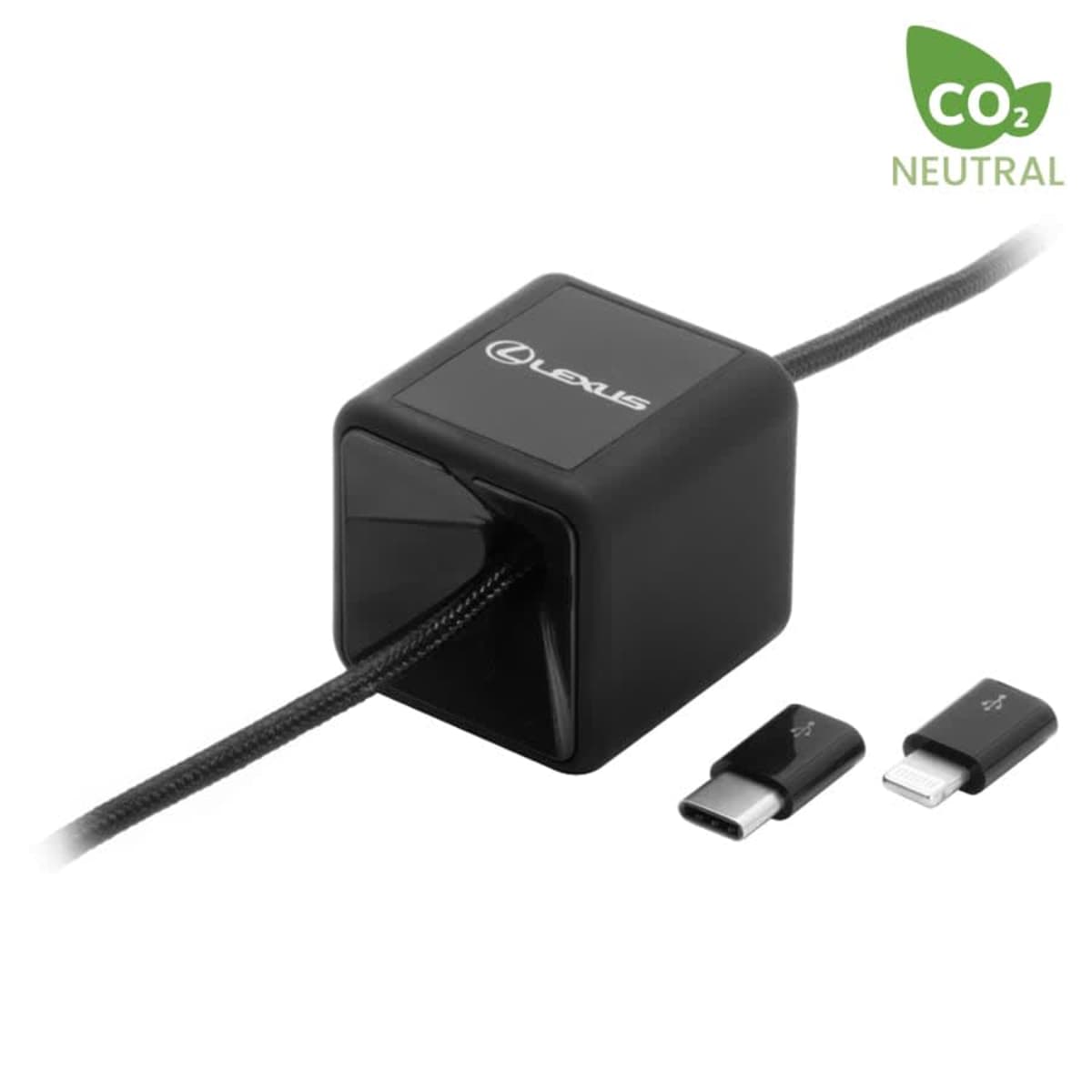 A black cube-shaped charging hub with the Lexus logo, featuring a braided cable with a USB-C connector inserted. Additional connectors for USB-A and Lightning are shown alongside. A CO2 Neutral symbol is visible in the top-right corner.