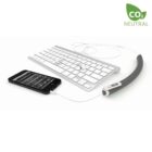 A white keyboard connected to a slim, curved electronic device with a display screen. An iPhone is also connected to the same device. A CO₂ NEUTRAL label is visible in the top right corner.