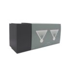 A rectangular cardboard box with a minimalist design featuring two stylized martini glasses with olives on the front. The box is primarily teal and black in color.