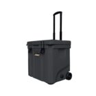 Dark grey wheeled cooler with a telescoping handle and a front label. The cooler has a sturdy build with dual latches on the lid, which is partially open. It sits on two wheels, designed for easy transport.