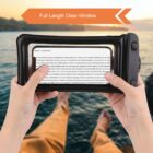 A person holds a waterproof phone pouch with a clear window displaying text. In the background, their legs are stretched out, seemingly over a blurred body of water. An orange arrow with the text Full Length Clear Window points to the pouch.