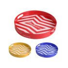 Three round serving trays with a chevron pattern and logo in the center. The large tray is red, while the two smaller trays are yellow and blue. Each tray has two cut-out handles and the phrase Be Your True Self printed on the side.