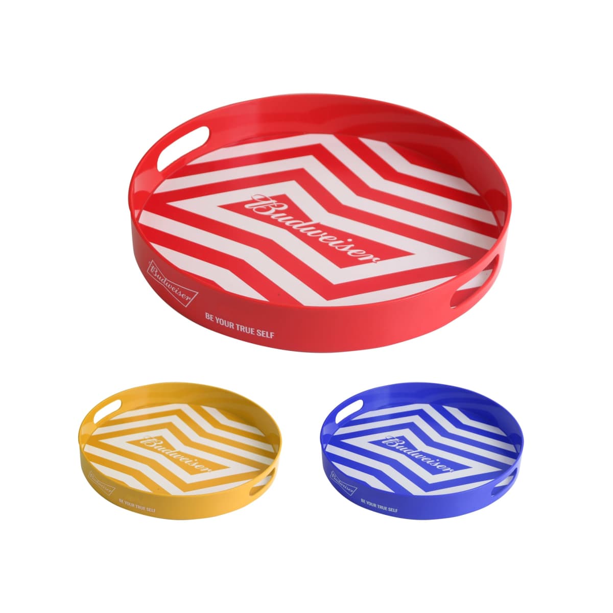 Three round serving trays with a chevron pattern and logo in the center. The large tray is red, while the two smaller trays are yellow and blue. Each tray has two cut-out handles and the phrase Be Your True Self printed on the side.
