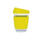 A clear reusable cup with a bright yellow silicone sleeve and matching lid, designed for hot beverages. The cup features a sleek, modern design and a slightly tilted lid for convenient sipping.