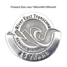 Silver pin with the inscription River East Transcona School Division 25 Years, featuring a stylized wave and book design. The text Product Size: max 100mmWx100mmH is displayed above.