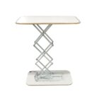 A modern, adjustable-height table with a white rectangular top and a scissor-lift style metal base. The base has a metallic finish and is mounted on a rectangular platform.