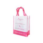 A white and pink reusable shopping bag with the text La Modeuse and Je ne DÉPENSE pas. Je me RÉCOMPENSE ! featuring a high-heeled shoe graphic. The website www.lamodeuse.com is printed at the bottom.