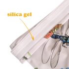 A close-up of a product label with an arrow pointing to a strip labeled silica gel in orange text. The product features colorful printed insects, including a detailed dragonfly design on fabric near the strip.
