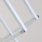 Close-up of a white folding metal frame, featuring intersecting bars connected by a bolt. The image highlights the geometric design and structural elements against a neutral background.