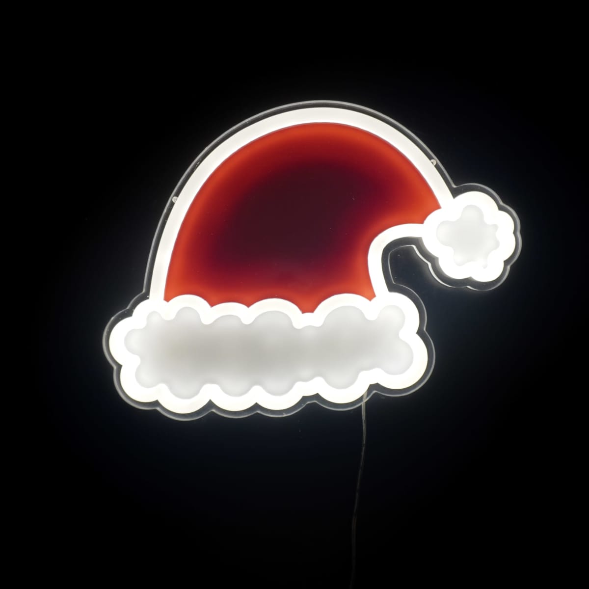 Neon sign of a Santa hat glowing against a black background. The hat is red with a white brim and pom-pom, outlined in bright white light.