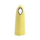 Yellow polka dot bottle cover with a black handle hole, standing upright, showcasing its tapered design and white stitching.