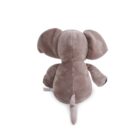 Back view of a plush elephant toy with large ears, a long trunk, and a small tail. Made of soft, gray fabric, it sits on a flat surface.
