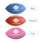 Three textured footballs with a lotus design logo. From top to bottom: Blue football labeled Blue, orange football labeled Natural, and pink football labeled Pink.