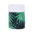 Cylinder-shaped object with green tropical leaf patterns and a white, soft-looking band around the top.