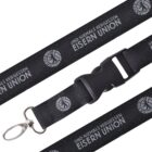 Black lanyard with silver clip, featuring the repeating text UND NIEMALS VERGESSEN EISERN UNION and a circular emblem. The lanyard includes a plastic buckle for easy detachment.