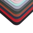 A close-up image of stacked, colorful leather swatches, featuring shades of grey, pink, mint green, brown, red, and black. The swatches have rounded corners and neatly stitched edges.