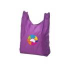 Purple reusable shopping bag with a colorful circular logo in the center, displaying various kitchen utensils like a whisk and spatula around a white chefs hat.