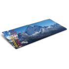 Rolled blue and gray outdoor blanket featuring a mountain landscape design. The words eXtrem and OUTDOOR are printed in red and yellow text on the blankets edge.