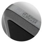 Close-up of a corner of a grey and black electronic device with a textured finish. The brand logo Swiss Peak is visible on the surface. The design features a rounded edge and sleek, modern appearance.