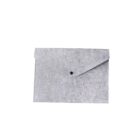 Gray felt envelope with a button closure on the front.