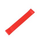 A red resistance band loop lies flat on a white background.