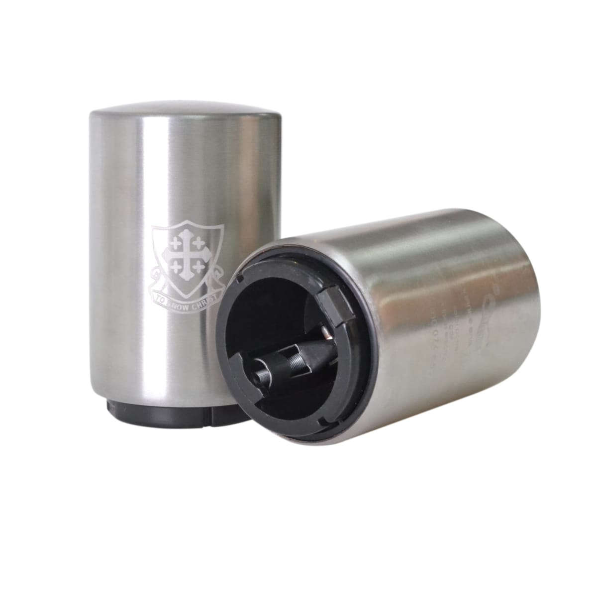 Two stainless steel travel coffee containers; one stands upright, and the other lies on its side, showing the opening mechanism. A shield emblem with text is on the surface of each container.