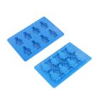 Two blue silicone ice cube trays sit side by side. One tray features humanoid figures in various poses, while the other depicts small robotic forms. Both trays have multiple molds aligned in rows.