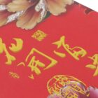 Close-up of Chinese calligraphy in yellow ink on a vibrant red background, with decorative floral elements and an intricate seal design. The image features artistic and cultural symbols commonly associated with Chinese art and tradition.